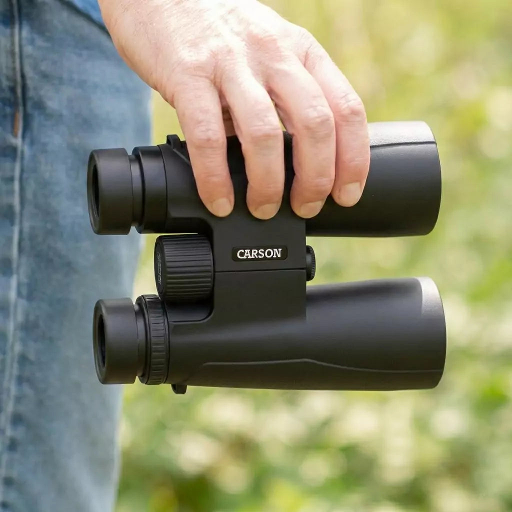 Person holding Compact Binoculars 8.5x36mm from Low Vision Store in outdoor setting.