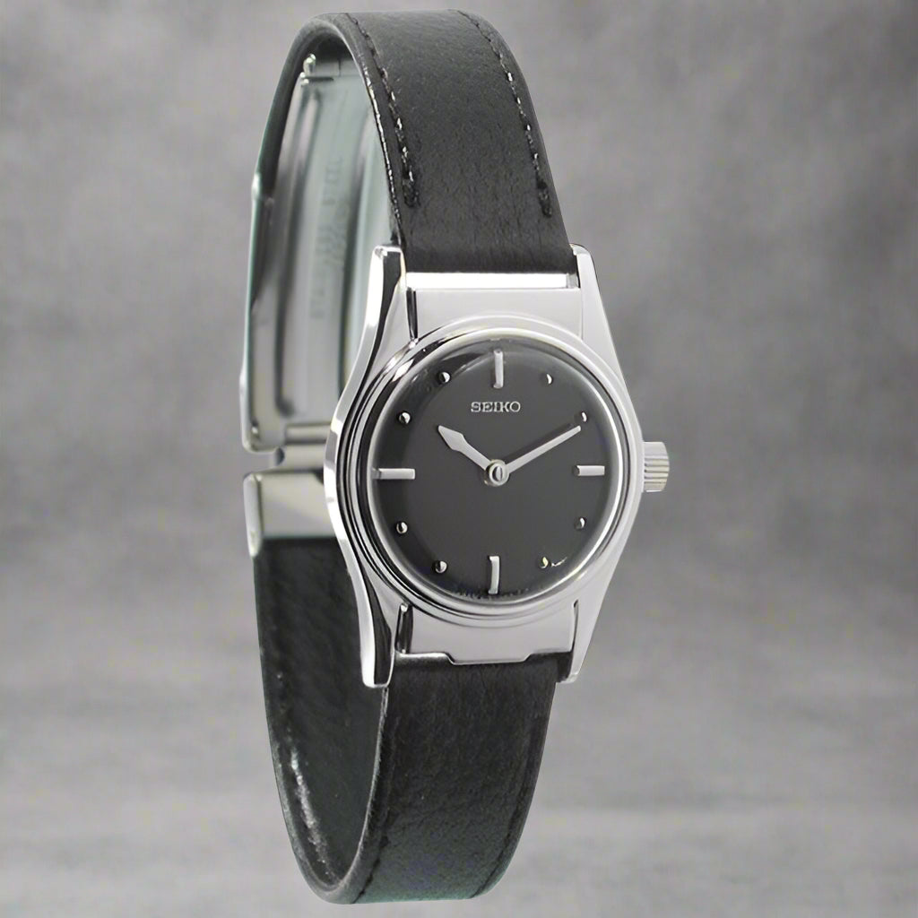 Seiko Braille watch for low vision featuring a sleek black strap and tactile Braille dots for accessibility.