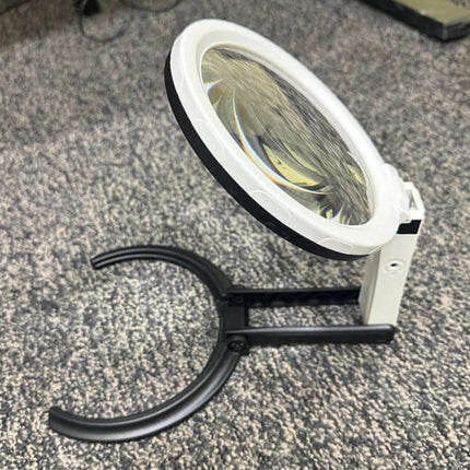Hands-Free Folding Stand Magnifier 12 LED with a 5-inch lens and sturdy base for hands-free use.