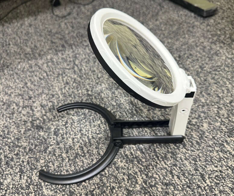 Hands-Free Folding Stand Magnifier 12 LED with a 5-inch lens and sturdy base for hands-free use.