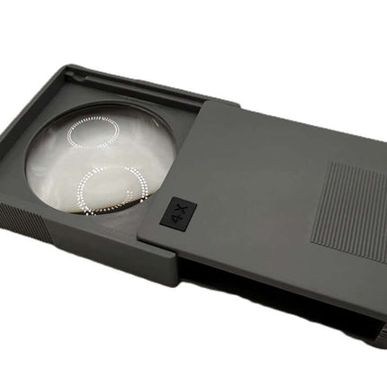 Pocket Magnifiers Slide up 4X in gray color, compact design with a sliding case for easy portability.
