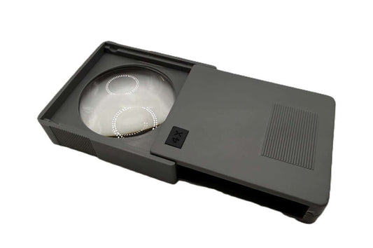Pocket Magnifiers Slide up 4X in gray color, compact design with a sliding case for easy portability.