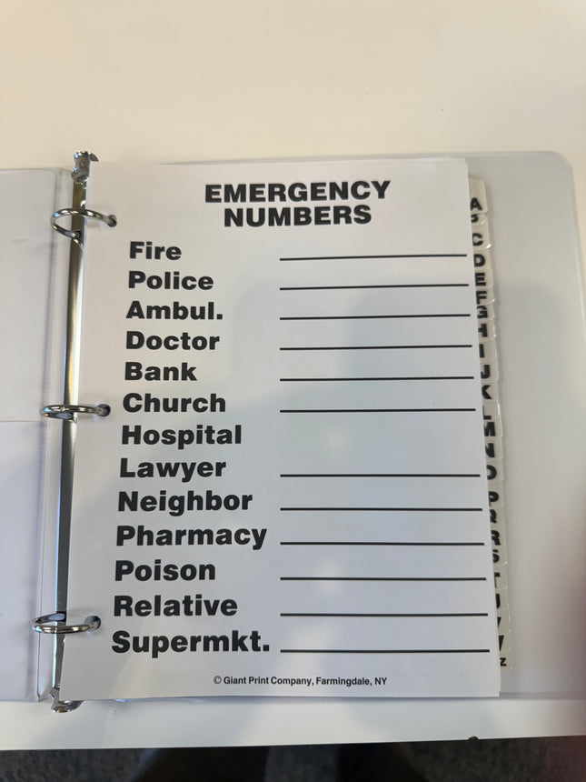 Large print address book for low vision emergency numbers page with readable text.
