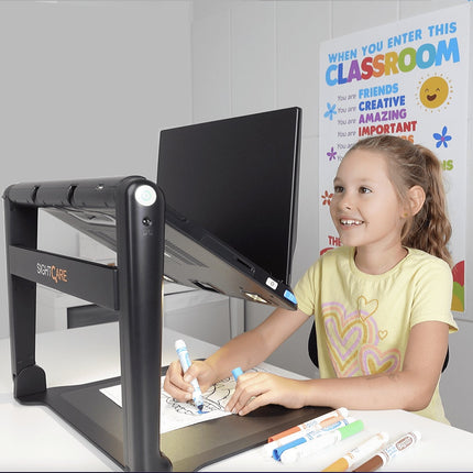 Child using CloverBook Lite XL for creative activities at a desk, surrounded by colorful markers.