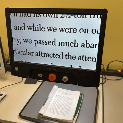 Used Reveal 16 video magnifier displaying text from a book on its 16-inch screen.