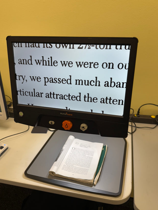 Used Reveal 16 video magnifier displaying text from a book on its 16-inch screen.