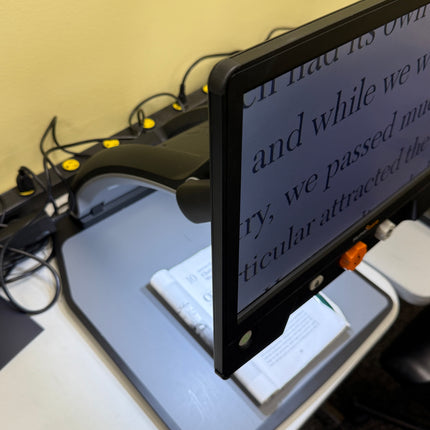 Used Reveal 16 video magnifier displaying text for easier reading on an adjustable screen.