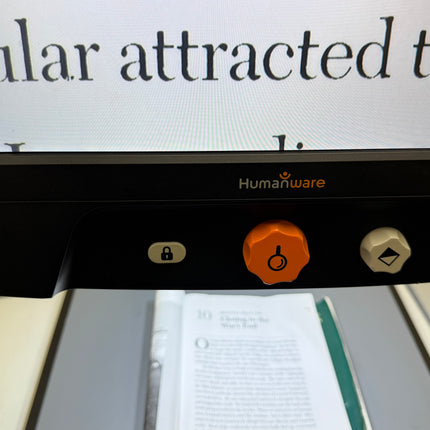Close-up of used Reveal 16 video magnifier controls displaying large text.