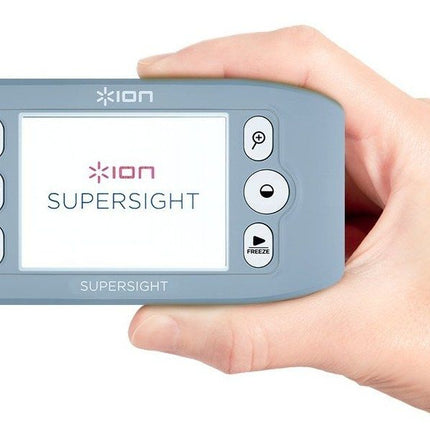 Handheld video magnifier from ION Supersight held in a hand, featuring a clear display and controls.