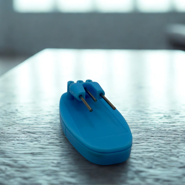 Liquid level indicator with sensors in blue color on a wooden table, showcasing its sleek design and functionality.