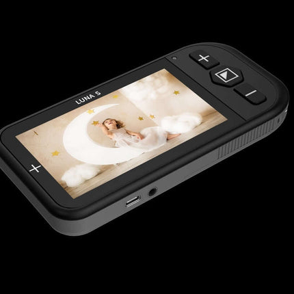 Luna S handheld video magnifier showcasing a clear display of a child sitting in a moon-themed setting.