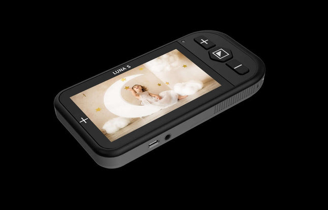 Luna S handheld video magnifier showcasing a clear display of a child sitting in a moon-themed setting.