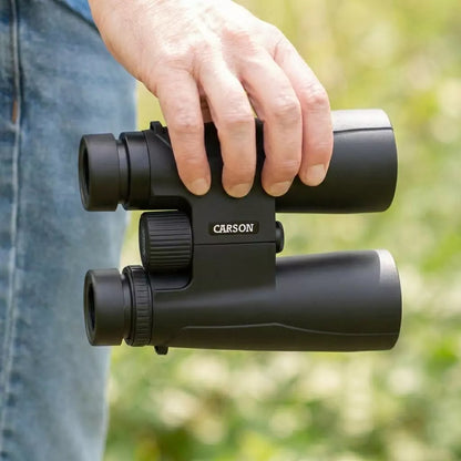 Person holding Compact Binoculars 8.5x36mm from Low Vision Store in outdoor setting.