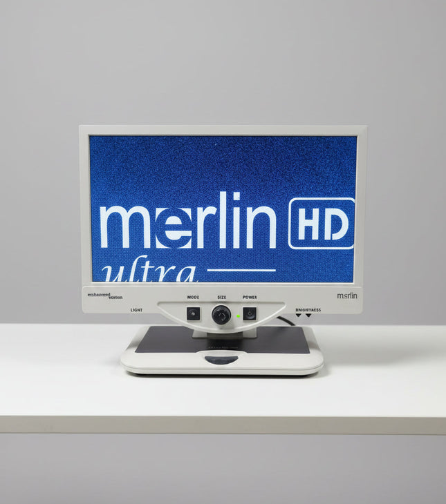 A Merlin Ultra HD monitor and tracking unit setup in a workshop or studio environment.