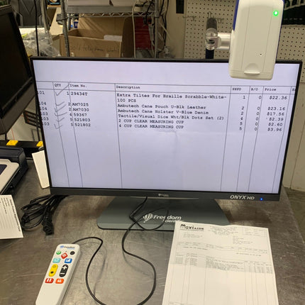 Used ONYX 22 inch video magnifier displaying text and items for sale on its HD screen.
