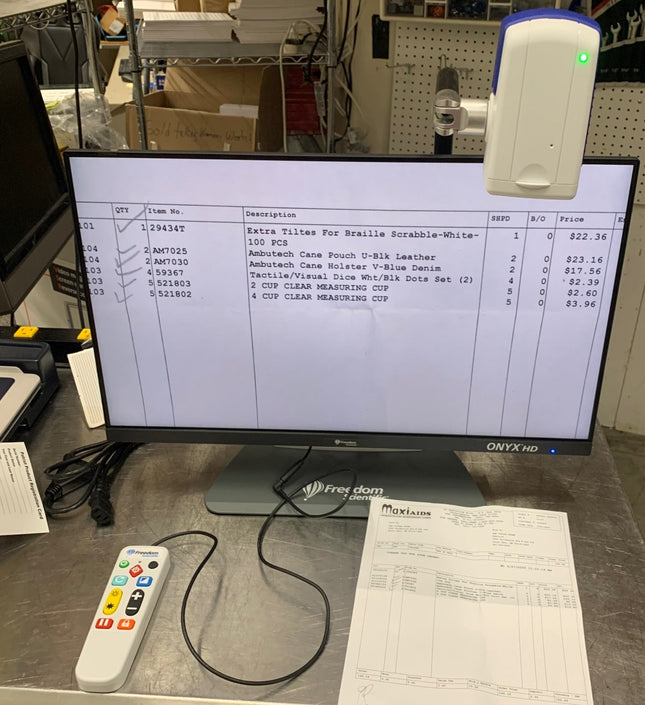 Used ONYX 22 inch video magnifier displaying text and items for sale on its HD screen.