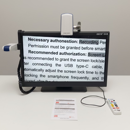 ONYX 24 inch HD magnifier with text to speech displaying enlarged document text on 24-inch screen in low vision workstation setup