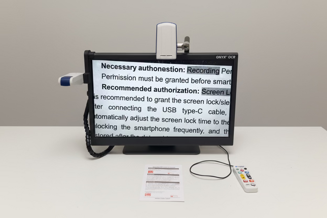 ONYX 24 inch HD magnifier with text to speech displaying enlarged document text on 24-inch screen in low vision workstation setup