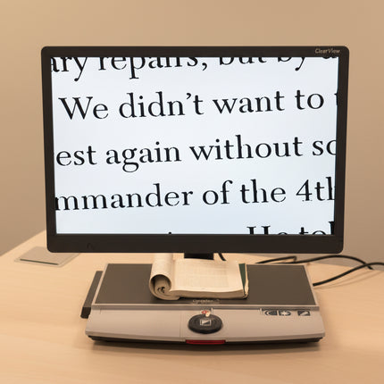 Monitor displaying text on a document reader with a yellow wall in the background