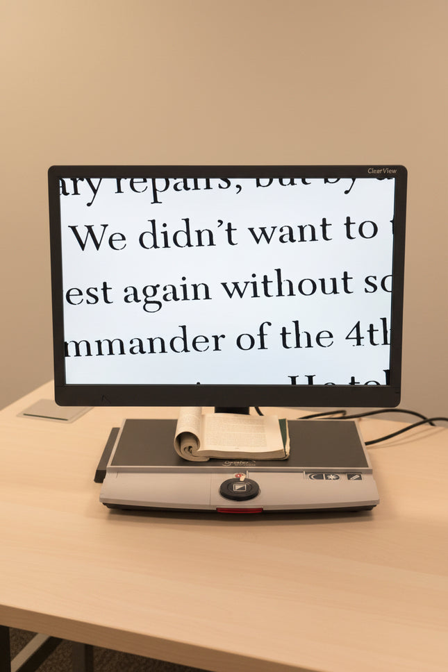 Monitor displaying text on a document reader with a yellow wall in the background