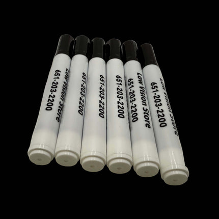 Set of white markers with black text on a white surface