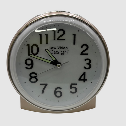 Round clock with white face and black numbers on a light gray background