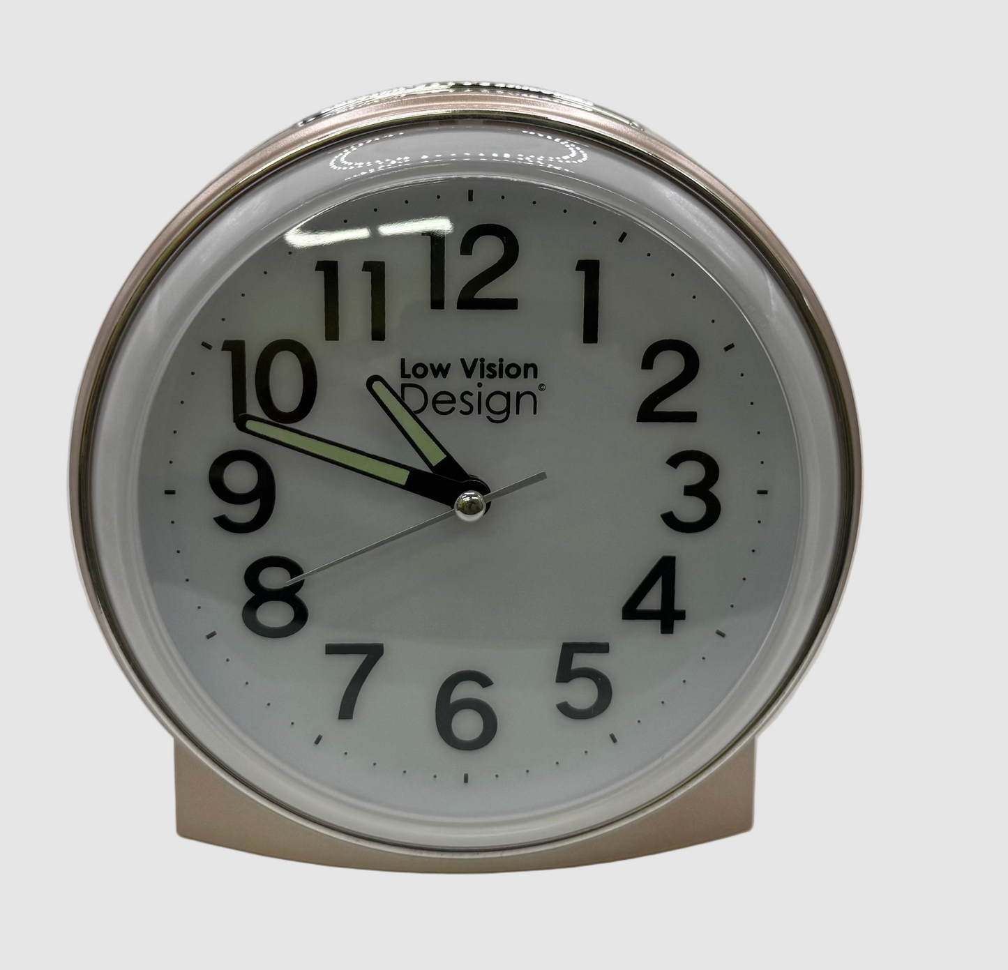 Round clock with white face and black numbers on a light gray background