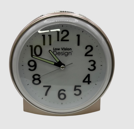 Round clock with white face and black numbers on a light gray background