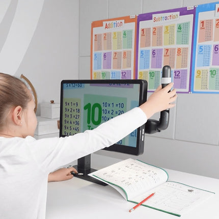 A child using the Mirror Pad Pro 3-in-1 wireless magnifier to view educational materials on a computer screen.