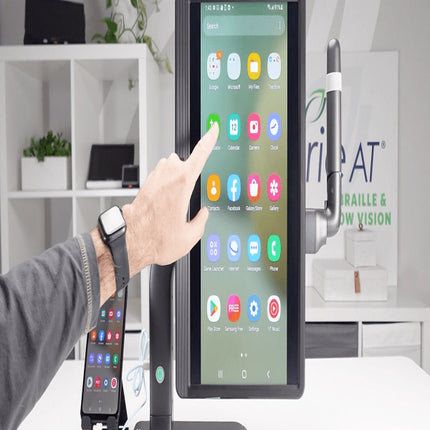 Person using the Mirror Pad Pro, a 3-in-1 wireless magnifier, to navigate a touchscreen interface.