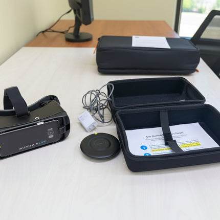 VR headset, controller, and accessories on a wooden table