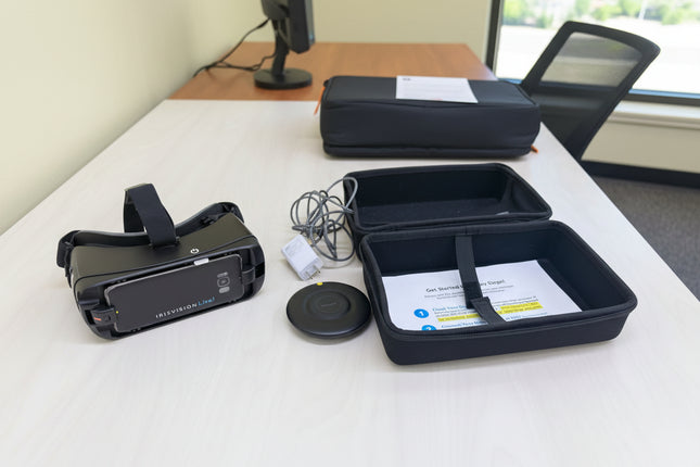 VR headset, controller, and accessories on a wooden table