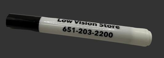 White marker with black cap on a white surface, displaying 'Low Vision Store' and phone number.