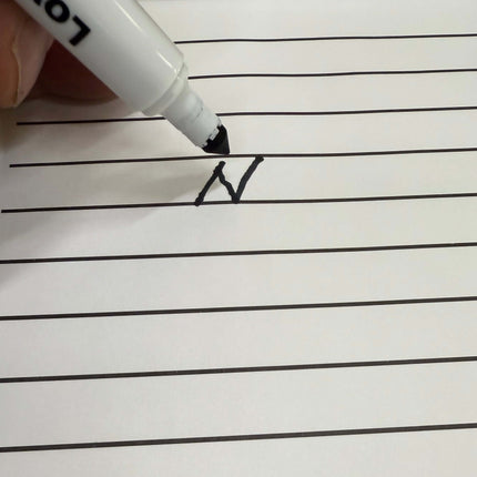 Handwriting practice sheet with a letter 'A' being written with a marker.