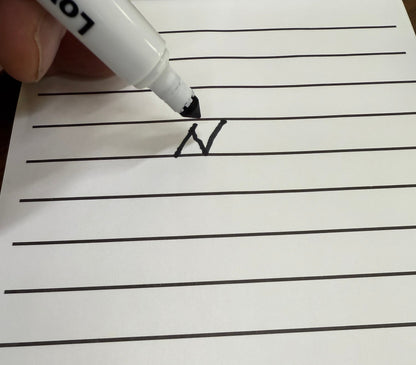 Handwriting practice sheet with a letter 'A' being written with a marker.