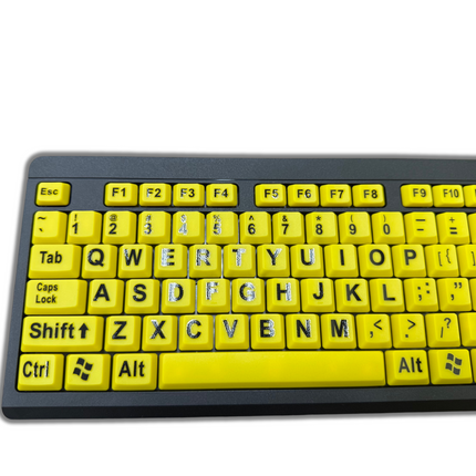 Large print computer keyboard with bright yellow keys and bold black letters for easy visibility.