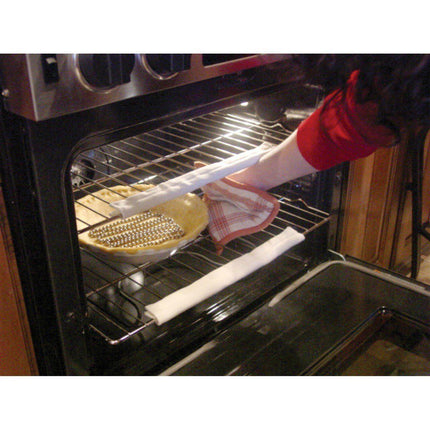 Person using cool touch oven rack guards while reaching for a pie in the oven, showcasing burn protection.
