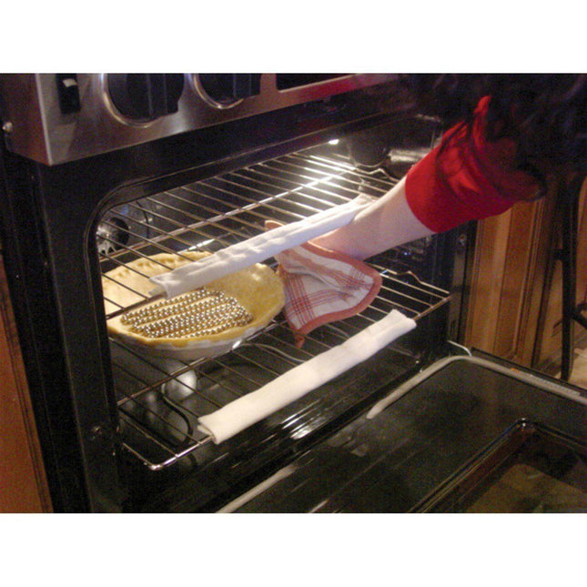Person using cool touch oven rack guards while reaching for a pie in the oven, showcasing burn protection.