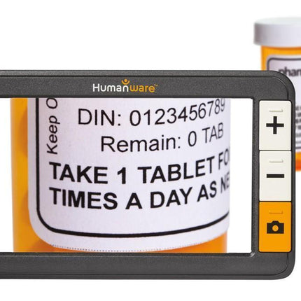Used Explore 5 Handheld Electronic Magnifier displaying medication label with HD screen and adjustable magnification.