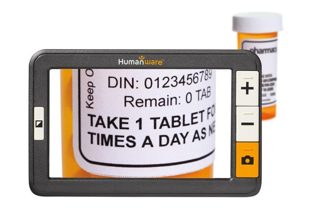 Used Explore 5 Handheld Electronic Magnifier displaying medication label with HD screen and adjustable magnification.