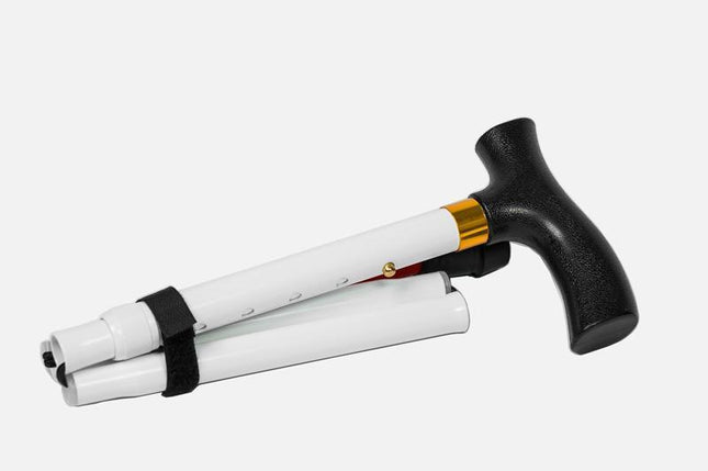 Folding adjustable support cane with a T-handle, folded and secured with a Velcro strap for easy carrying.