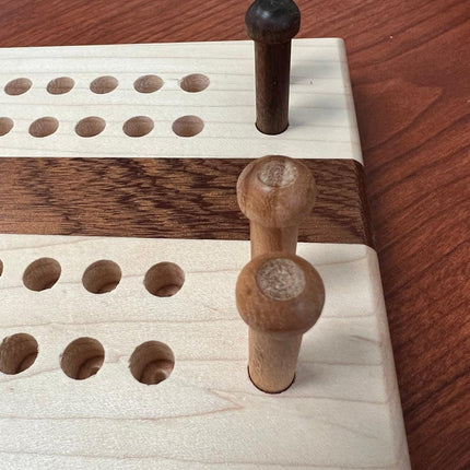 Hand crafted jumbo size cribbage board with pegs and holes, showcasing wooden craftsmanship.