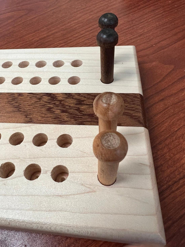 Hand crafted jumbo size cribbage board with pegs and holes, showcasing wooden craftsmanship.