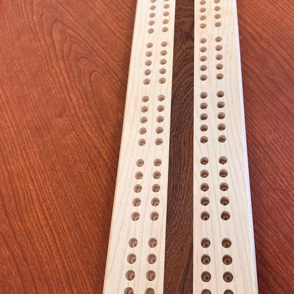 Hand crafted jumbo size cribbage board featuring a beautiful design and wooden pegs.