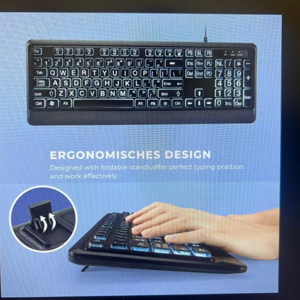 Large text LED backlit keyboard with ergonomic design and foldable stand for optimal typing convenience.