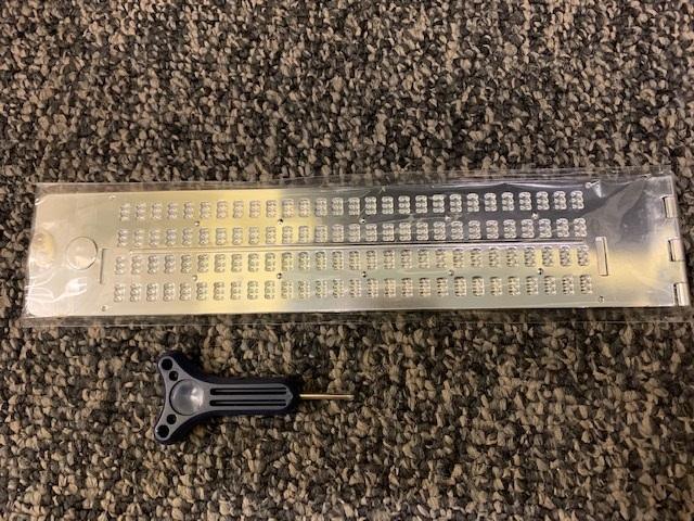 Lightweight metal slate braille board featuring four lines, 28 cells, and a stylus included.