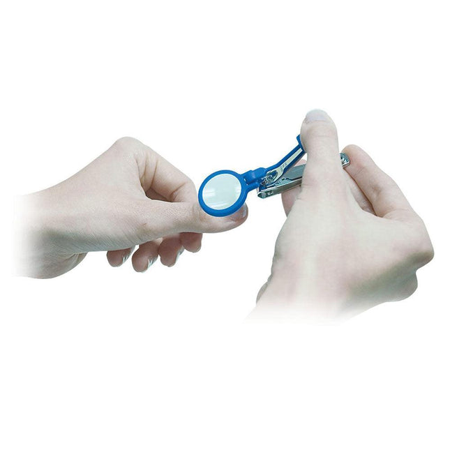 Person using a magnifying nail clipper with LED light; features a removable 5x magnifier for precise nail trimming.