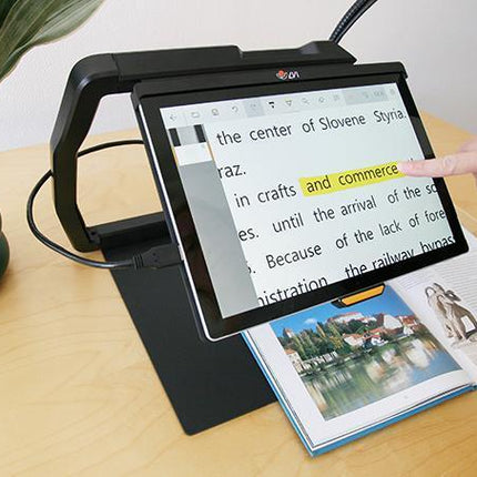MagniLink TAB tablet solution for distance viewing in use with a book on a tabletop.