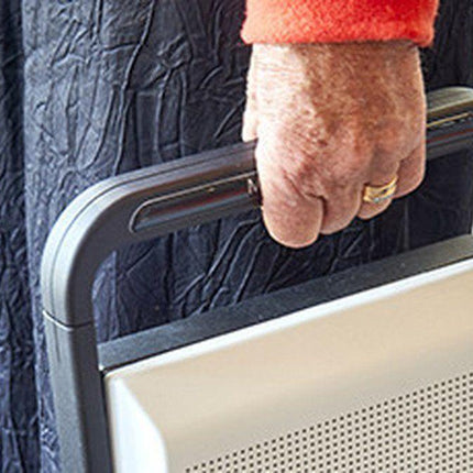 Hand holding the MagniLink Voice 2 text to speech device, showcasing its portability and compact design.