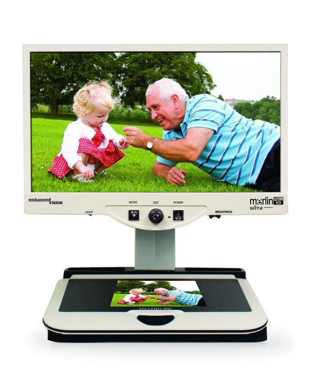Merlin 24" ultra – Full HD Video Magnifier displaying vibrant images of a child and an elderly man outdoors.